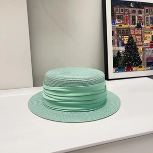 Mint green women's flat top boater straw hat with layered silk ribbon for summer travel