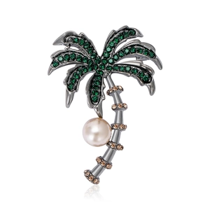 Elegant silver coconut tree brooch with green rhinestones and a large white pearl drop