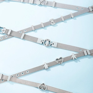 Silver mesh wristbands with heart and bow charms on a light blue background