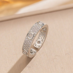 Luxurious silver open ring with pave-set cubic zirconia and round patterns on warm fabric