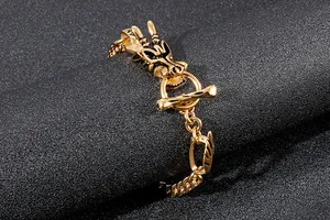 Gros plan d'un bracelet dragon doré avec un fermoir à bascule en T en acier poli