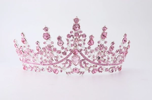Close-up of pink crystal crown with silver metal frame and teardrop rhinestones