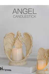 Detailed view of prayer angel resin candle holder with a glowing LED pillar candle