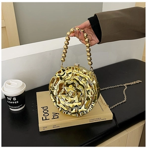 Detailed view of a golden rose-shaped metal clutch bag with layered petal textures