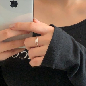 Macro shot of 925 silver double-band minimalist ring with rectangular zircon stone detail