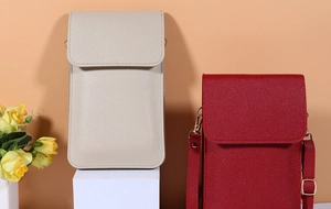 Detail showing the beige and dark red mini leather phone bags with gold metal hardware