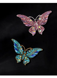 Detailed close-up of sparkling crystal butterfly brooches in pink and royal blue options