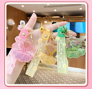 Detail of star-shaped drifting bottle acrylic keychains with colorful liquid glitter
