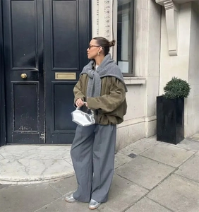 Olive green pilot jacket with shoulder buckles and cinched waist for women's street style