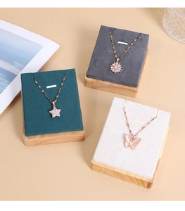 Detailed view of rose gold pendants on premium velvet display stands in various colors