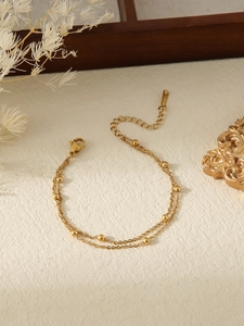 Detailed macro view of 18k gold plated double-layer bead chain with lobster clasp