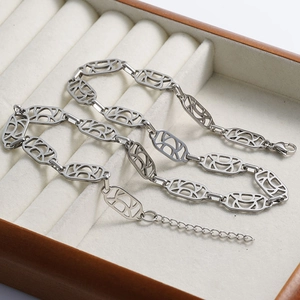 Detail of silver hollow oval link chain featuring a secure lobster clasp and extender
