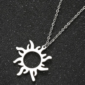 Silver hollow sun pendant necklace with artistic flame rays on a textured black background