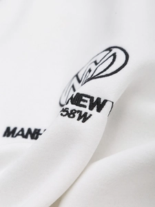 Detail shot of white cotton sweatshirt featuring black letter embroidery and fabric texture