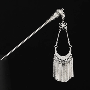 Detail of silver Hmong hair stick with hollow flowers and crescent moon fringe tassels