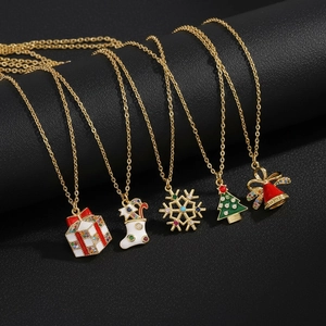 Detailed macro view of Christmas necklace set with enamel charms on black textured background