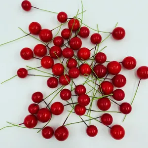 Christmas decoration set featuring artificial shiny red berries with green stems on white