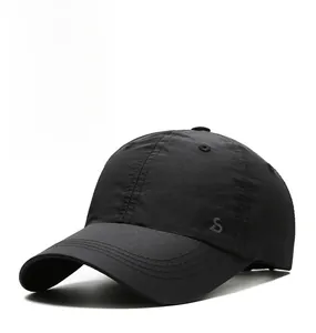 Detailed close-up of quick-dry black sports cap fabric with embroidered S logo and brand name
