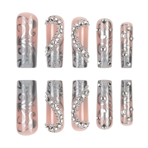Long coffin press-on nails with nude pink base, silver vine patterns and rhinestones