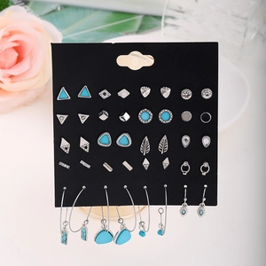 Detail of 20-pair silver alloy earring set with turquoise stones on black display card