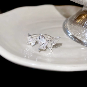 Macro shot of butterfly open ring featuring white shell wings and zircon micro-pave details