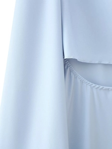 Detail of light blue satin dress showing elegant side slit and ruched fabric texture