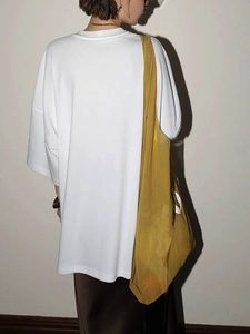 Minimalist oversized white cotton T-shirt featuring batwing sleeves and back view silhouette