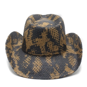Close-up of woven straw cowboy hat featuring bold black and yellow pattern detail