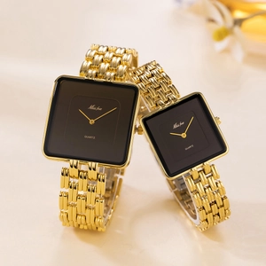 Detail showing two gold square watches with black faces for couples on beige background