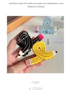 Detail showing acetate pencil-shaped hair claw dimensions 7.9cm x 4.7cm x 4.8cm