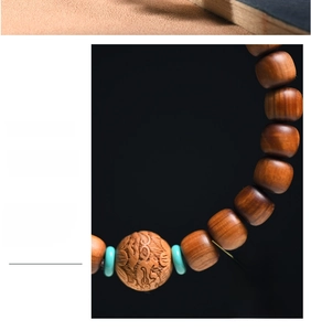 Close-up of high-density cypress wood beads with turquoise accents and dragon carving