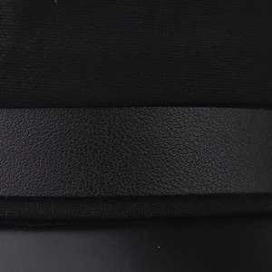 Detailed close-up showing the combination of black litchi grain leather and knitted fabric