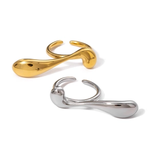 Abstract 18k gold and silver stainless steel teardrop rings on white background