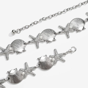 Detailed close-up of Bohemian waist chain featuring silver starfish and shell charms with pearls