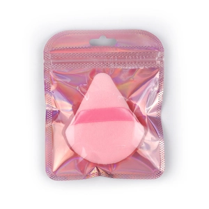 Pink triangular powder puff with ribbon handle in a holographic zip lock packaging