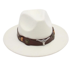 Close-up of white felt cowboy hat featuring brown leather band and silver bull head detail