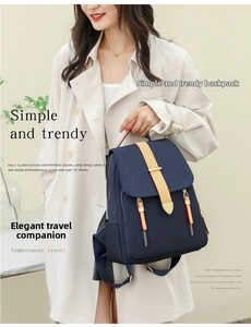 Detail of dark blue waterproof nylon backpack with side pockets and zipper accents