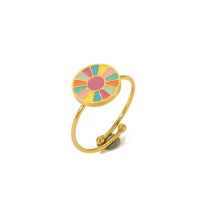 Close-up of golden stainless steel ring with colorful enamel sun pattern and open design