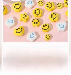 Detailed view of yellow and white smiley face ceramic beads for DIY jewelry making