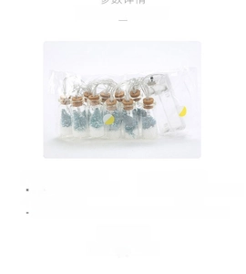 Detail view of DIY LED wishing bottle light string with miniature Christmas trees and fake snow