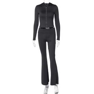 Detail of a black two-piece tracksuit with a zip-up hoodie and high-waisted flare trousers