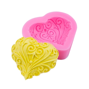 Pink heart-shaped silicone mold with vine texture and finished yellow resin heart model
