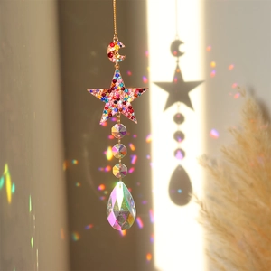 Rainbow light reflections from a crystal suncatcher with moon and star metal frame