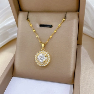 Macro detail of luxury gold titanium necklace with double-circle crystal pendant in jewelry box