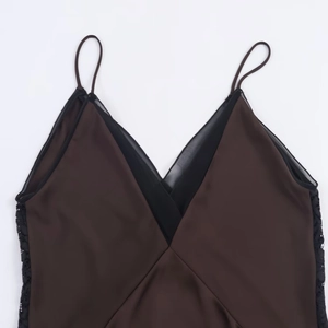 Close-up of brown satin V-neck camisole top with delicate black lace trim detailing