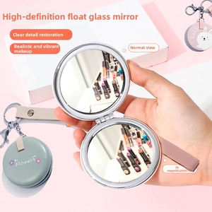 Detail showing foldable dual-sided compact mirror with a 2x magnification and 1:1 HD view