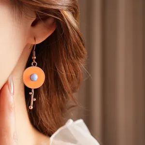 Vintage orange enamel round drop earrings with blue bead on a rose gold hook for women