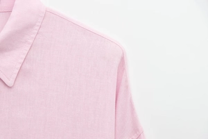 Close-up of soft pink long sleeve shirt showing detailed cotton linen woven texture