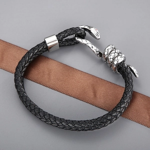 Men's double-layer black braided leather bracelet with silver snake head clasp on grey background