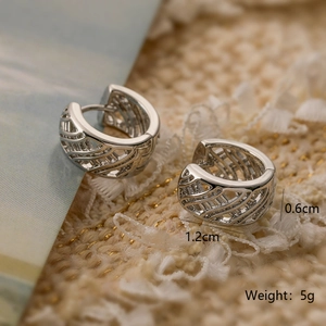 Macro shot showing hollow woven texture and dimensions of silver hoop earrings